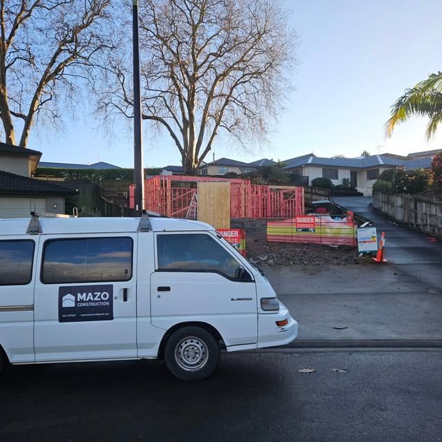 Mazo Construction van parked at a residential framing site