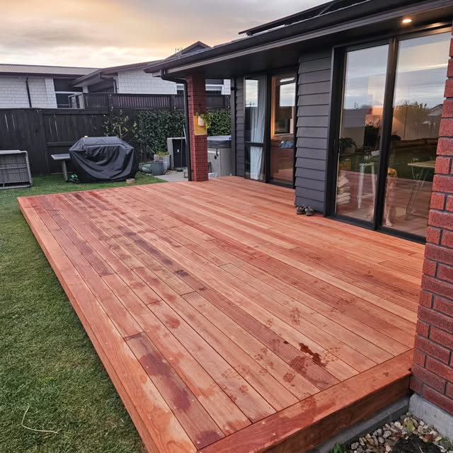 Finished timber deck beside a modern weatherboard house