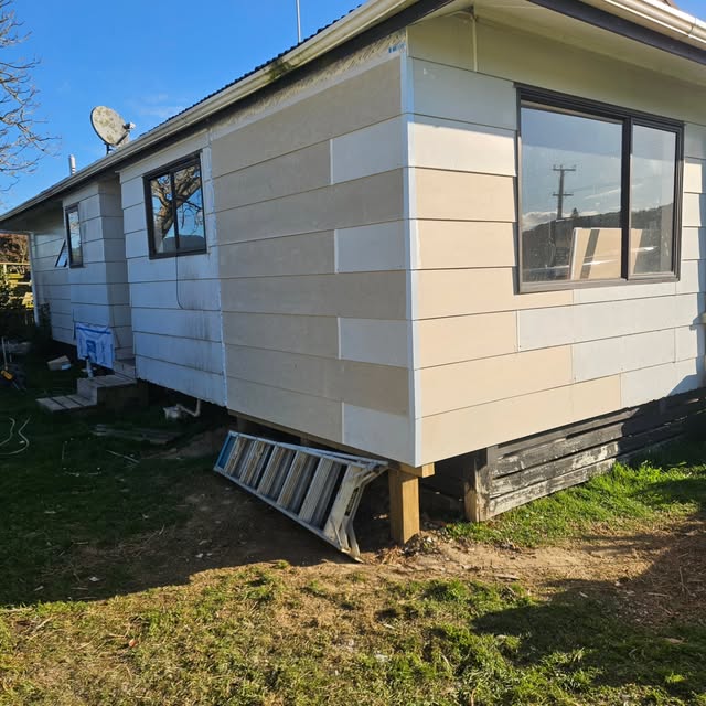 Weatherboard cladding being installed on a house exterior